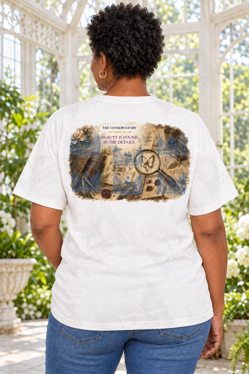 Mature Black woman modeling the Philosophy Landscapes with Pocket Motifs Beauty design on the back; faint diagonal Wondergate watermark across the entire image