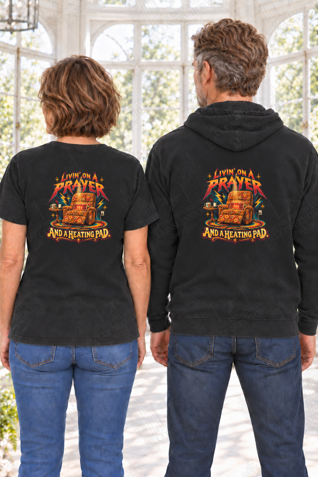 Livin’ on a Prayer and a Heating Pad — back print on approved middle-aged T-shirt and hoodie models; proportional 10-inch-wide artwork; faint diagonal Wondergate watermark across the entire image